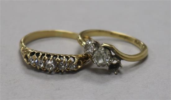 An 18ct gold and graduated five stone diamond ring and an 18ct gold and two (ex 3) stone diamond crossover ring.